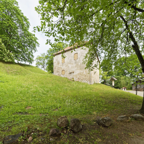 Bild: Der Pulverturm von Kandava lehnt sich eng an den Burgberg an.